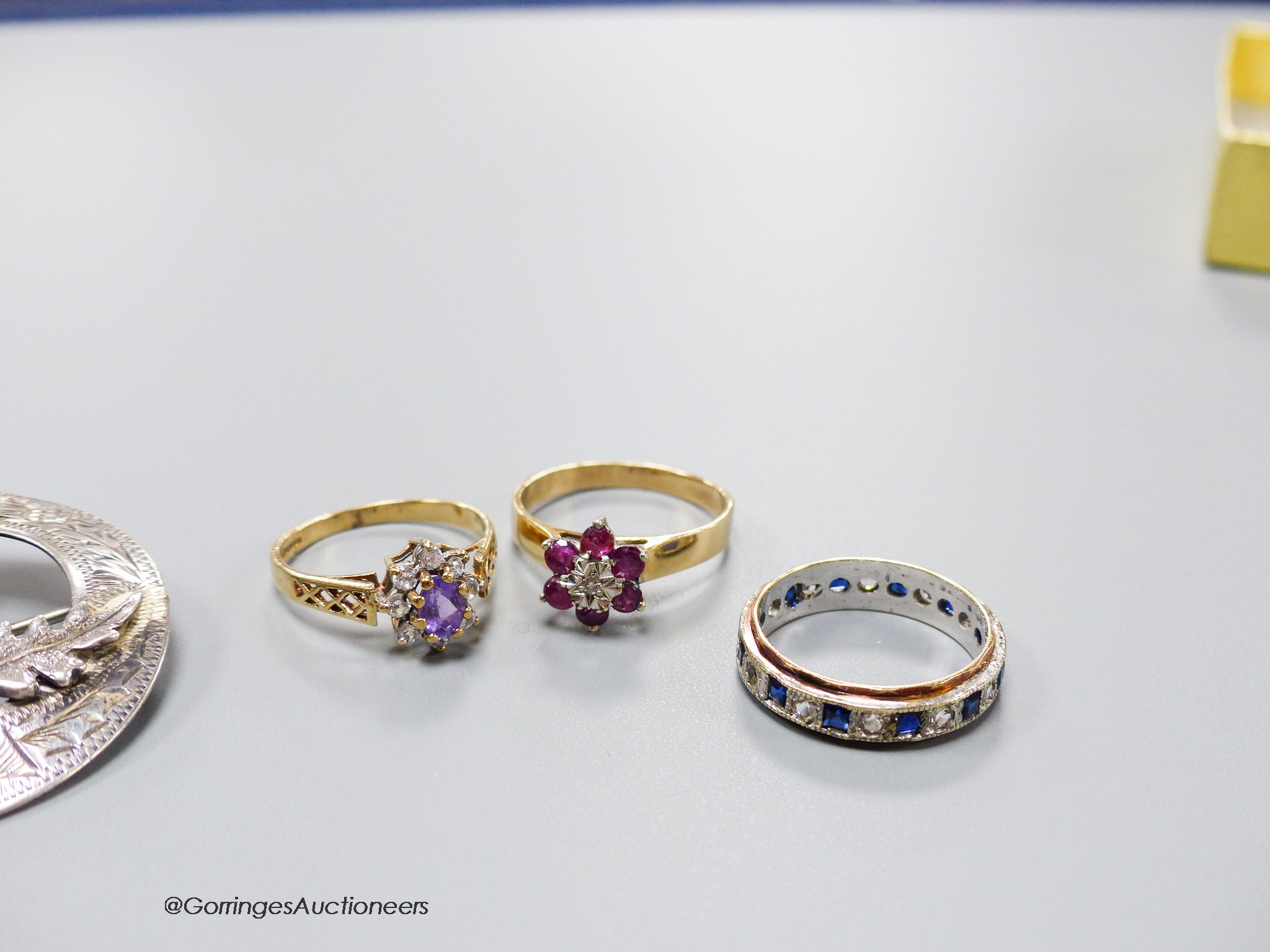 Three assorted modern 9ct gold and gem set dress rings, gross 7.3 grams, a Scottish silver Iona brooch and one other Scottish gem set brooch.